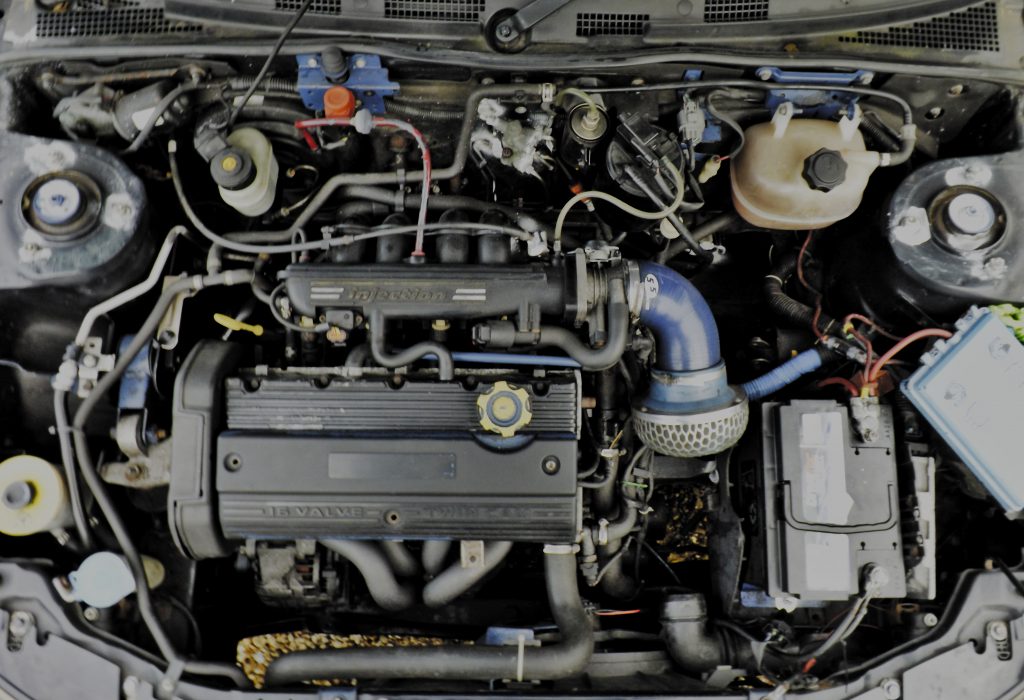 A tight engine bay, complete with a mushroom air filter