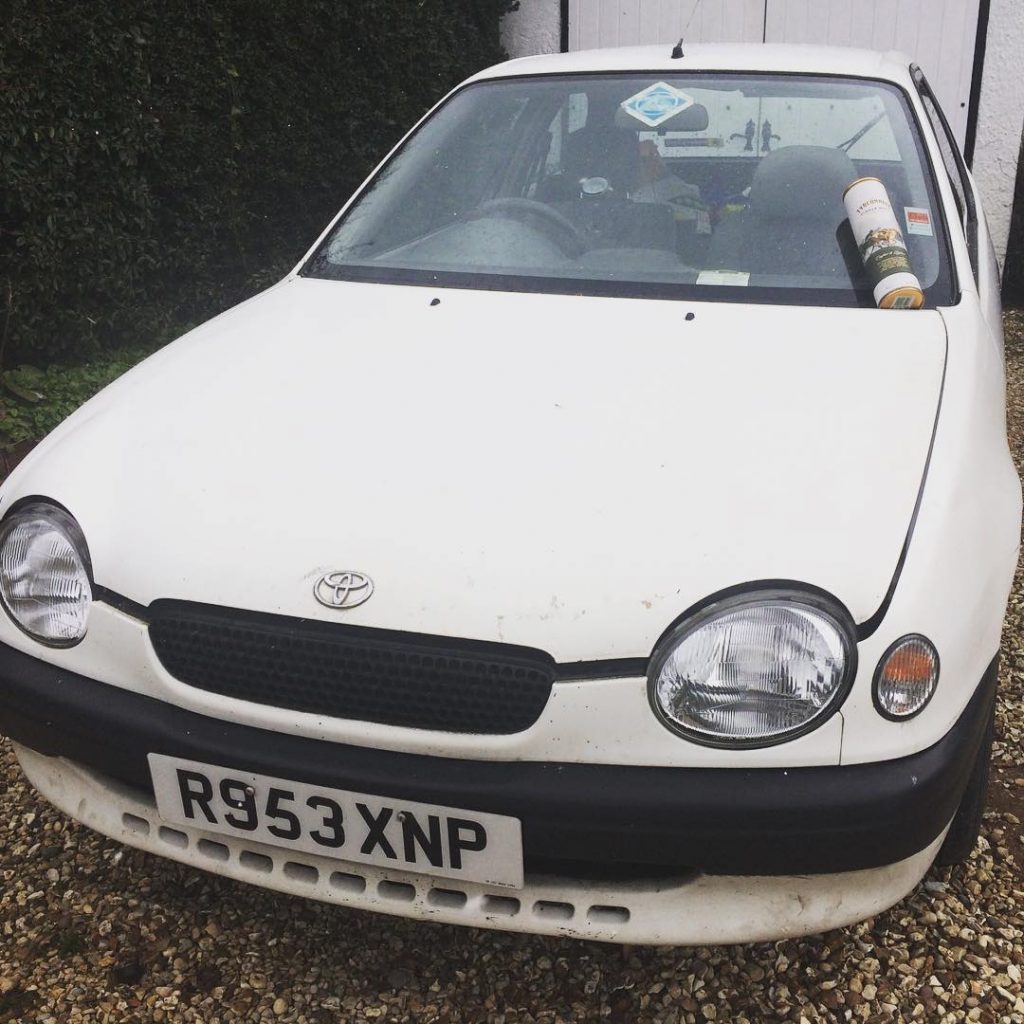 Paddy the Toyota Corolla E11 celebrating his 21st birthday in style - with a bottle of whiskey!