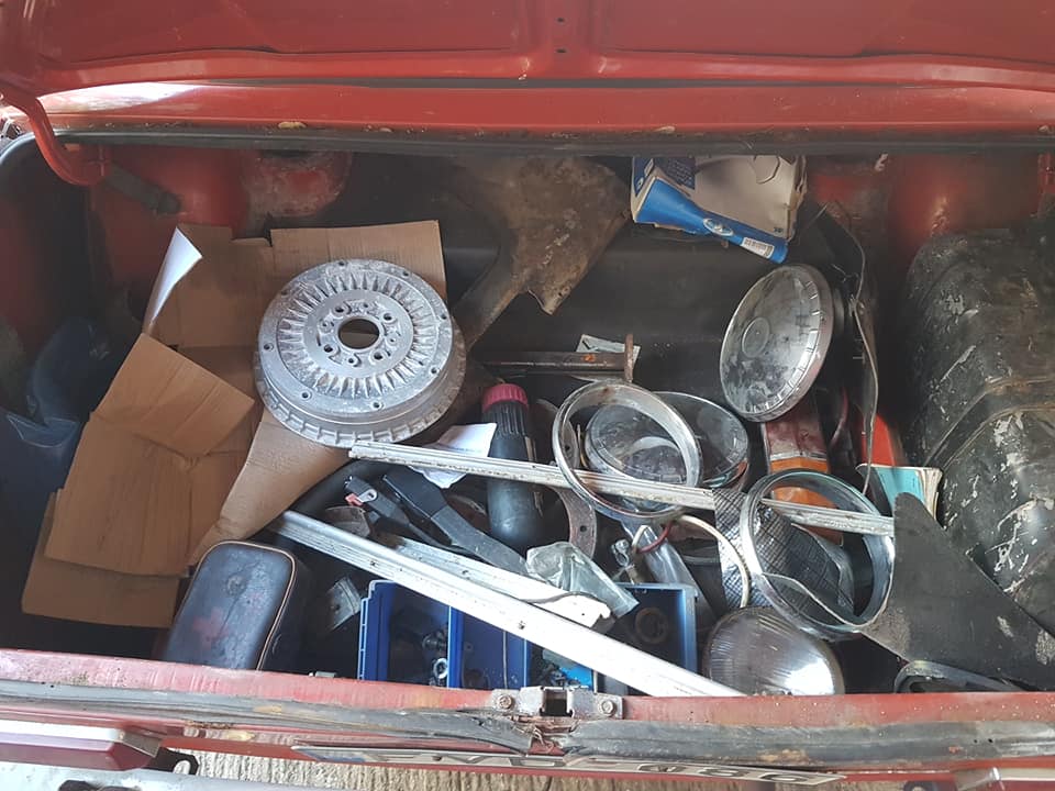 A boot full of spares for this Lada 2101. New brakes, an empty first aid kit, and a water bottle.