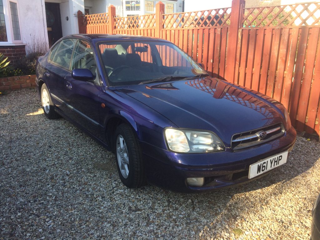 My (very short lived) Blue Subaru Legacy 2.0 GL, complete with no turbo, for the price of a bottle of whiskey.